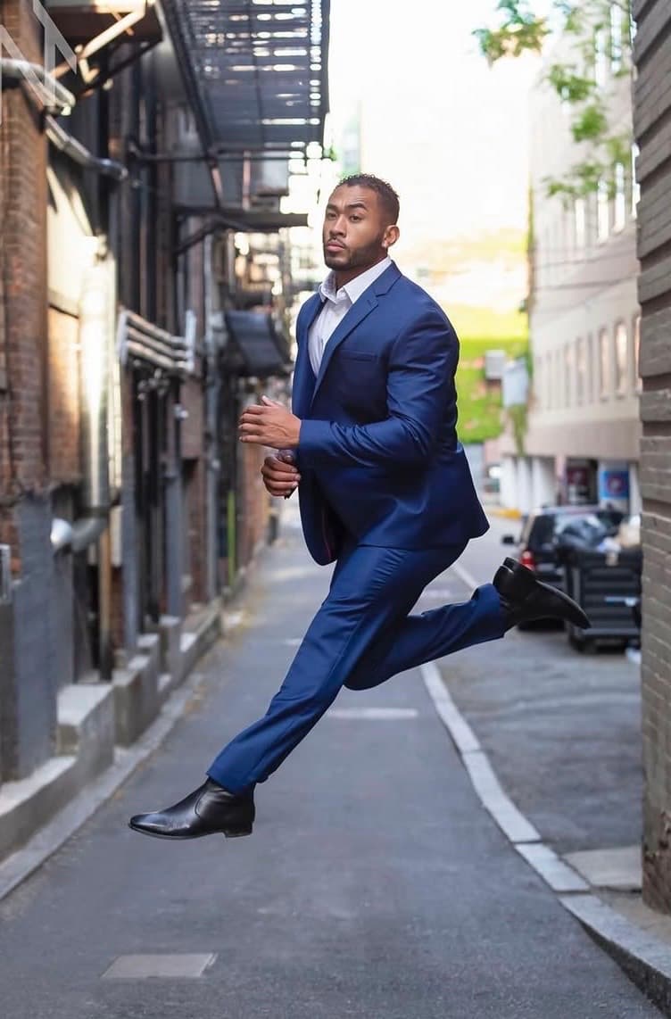 Charles Jourdan in a suit, moving through the city
